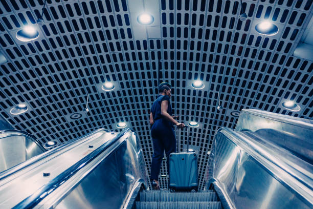istock confident black businesswoman with a rolling suitcase on the go 927711570
