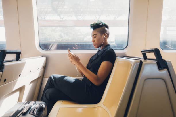 istock young hip businesswoman using cellphone on the train 927711672