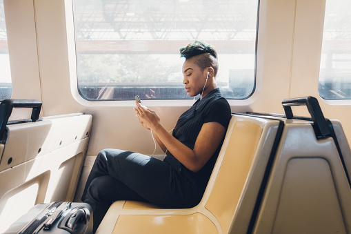 Young hip black businesswoman using her cellphone.