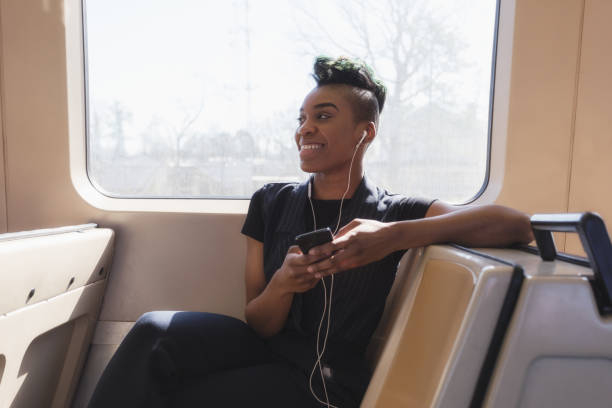 istock young hip businesswoman using cellphone on the train 927711718