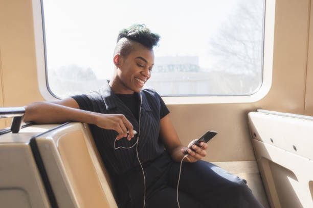 istock young hip businesswoman using cellphone on the train 927711722