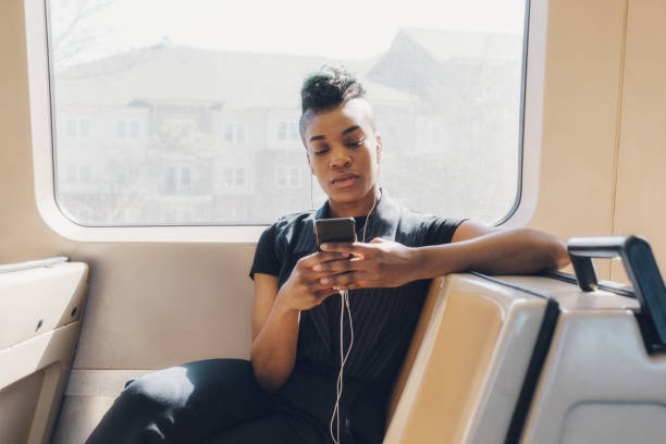istock young hip businesswoman using cellphone on the train 927711724