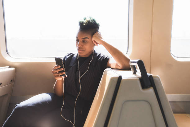 istock young hip businesswoman using cellphone on the train 927711728