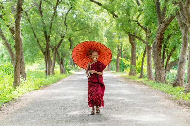 istock Smiling Novice Monk Green Alley Bagan Myanmar 927717726