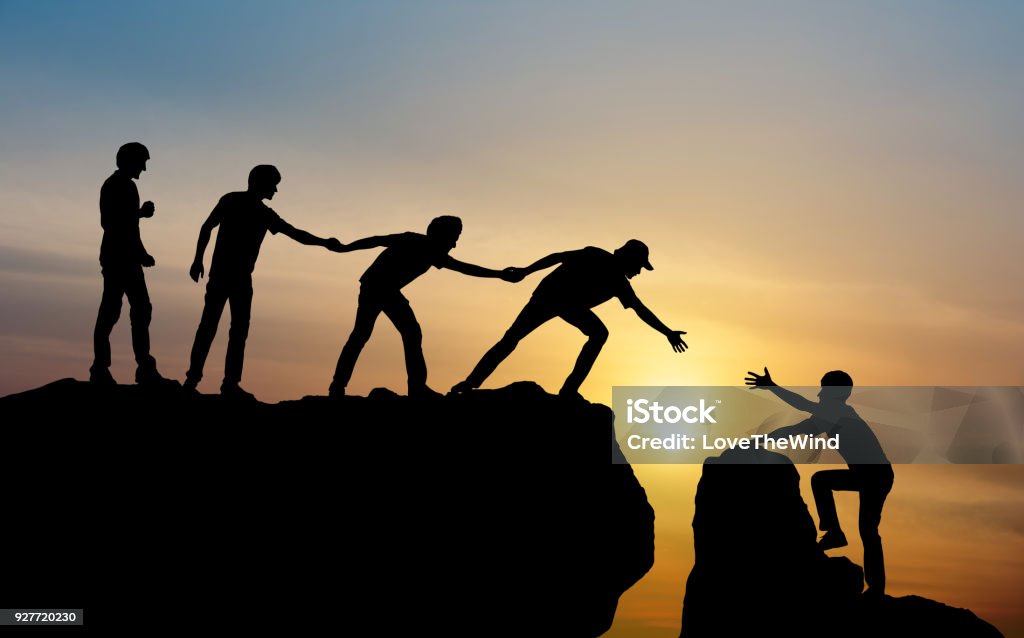 Group of people on peak mountain climbing helping team work , travel trekking success business concept Support Stock Photo