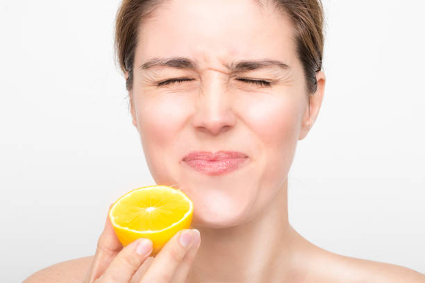 Beauty Female face with fresh lemon fruits stock photo