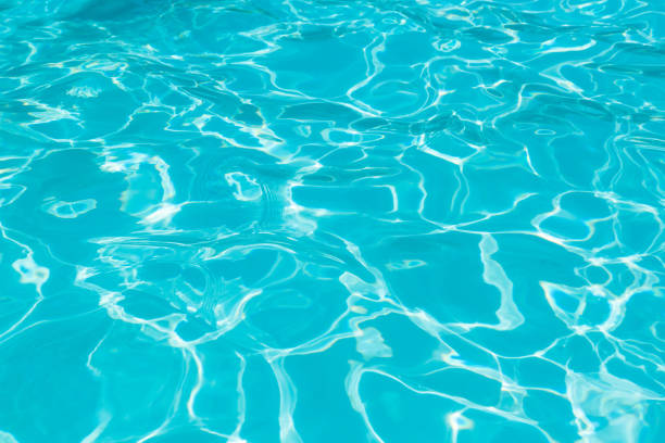 istock Top view blue water in swimming pool with sun reflection 927726966