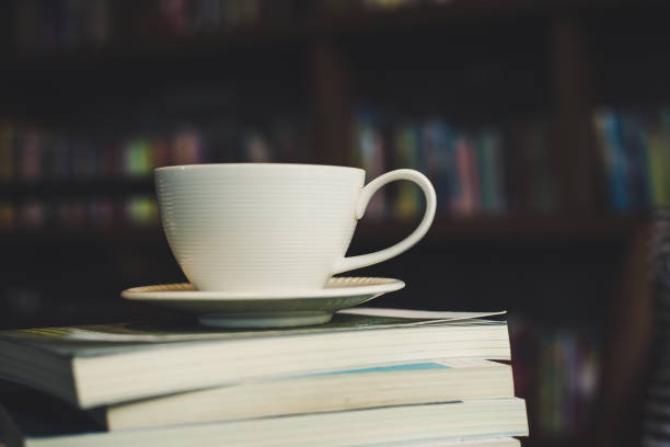 istock Coffee cup and stack of books on wood table. Education concept. 927727456