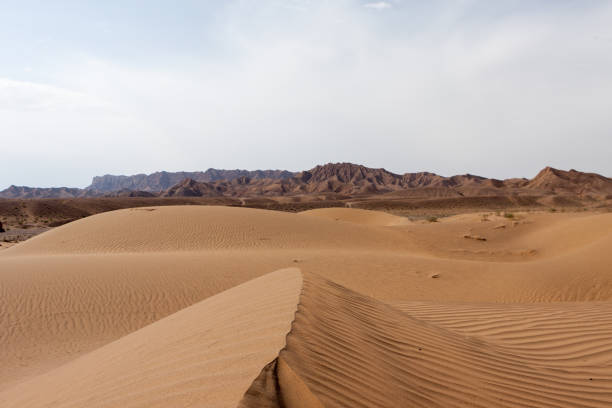 istock Dasht-e Kavir desert sand dunes with mountains on Horizon, Iran. 927730322