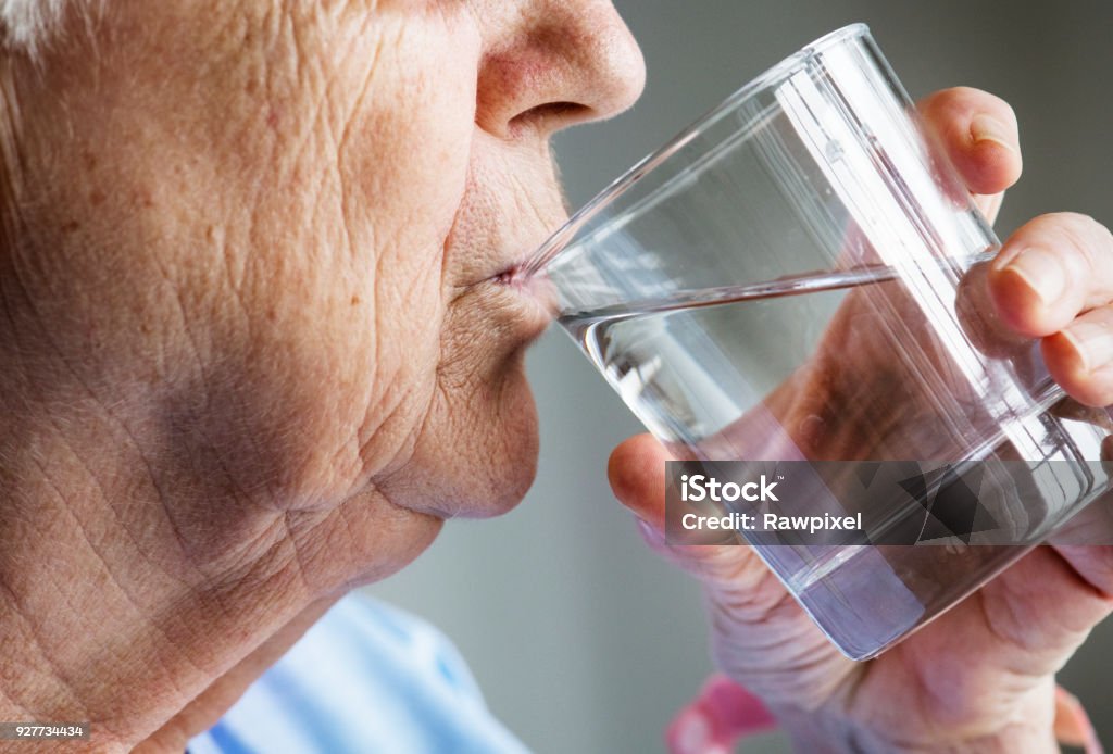 Side view of elderly woman drinking water Senior Adult Stock Photo