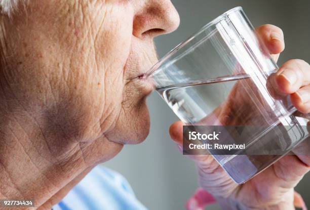 Side View Of Elderly Woman Drinking Water Stock Photo - Download Image Now - Senior Adult, Drinking, Drinking Water