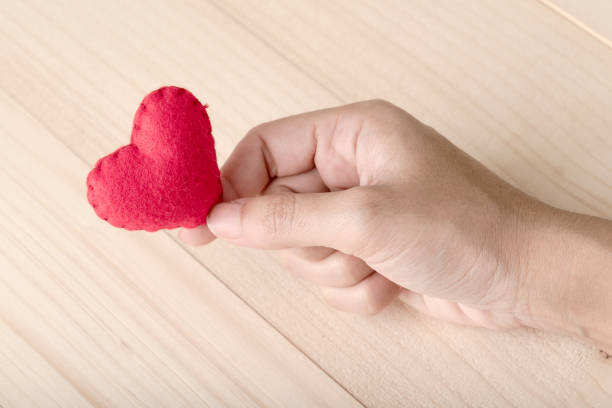 istock Giving a Red Heart on Wood Background 927734600