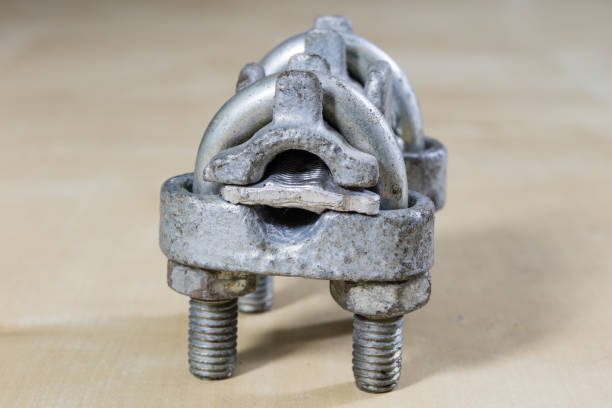 Old garden accessories. Rusty hose clamps on the workshop table. Light background.