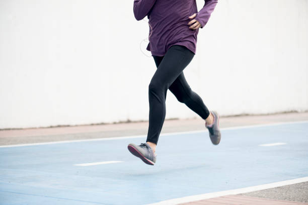 istock White woman running on track 927741576