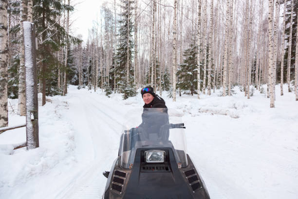 istock A man is riding a snowmobile in the winter forest 927747586