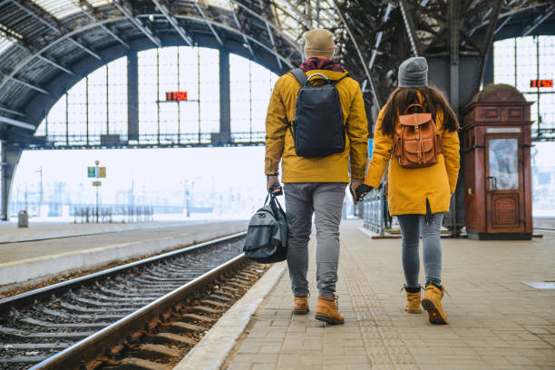 couple at railway station wiring for train