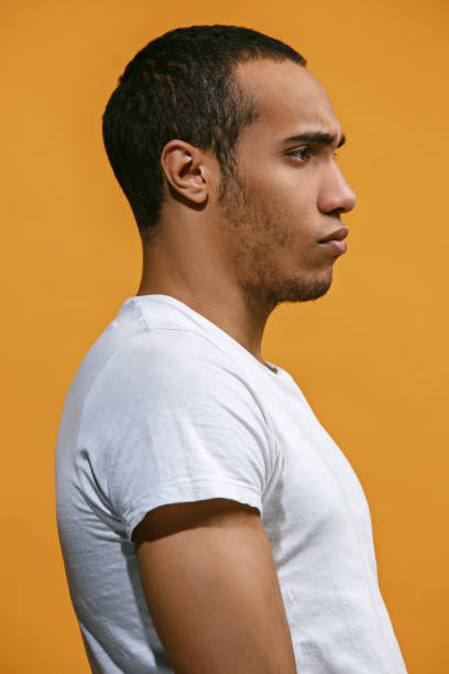 istock Serious Afro-American man is looking serious against orange background 927752762