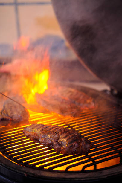 istock Delicious grilled beef steak with fire on background 927756966