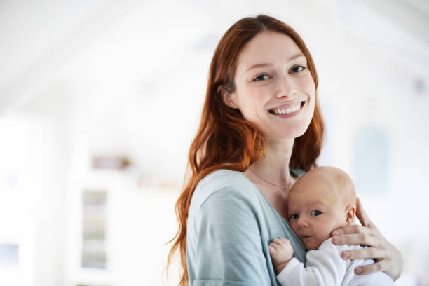 istock Smiling mother embracing newborn son at home 927757264