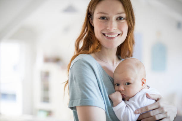 istock Smiling mother embracing newborn son at home 927757392