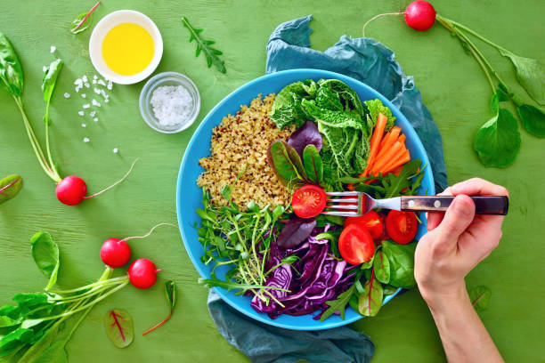 fresco succoso e croccante buddha ciotola pasto sano con quinoa e germogli verdi - folding hands immagine foto e immagini stock