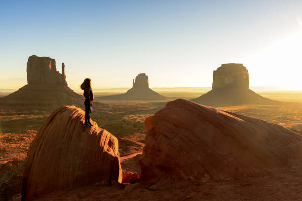 a tourist woman watching sunrise at monument valley, utah, usa - monument valley usa panoramic imagens e fotografias de stock