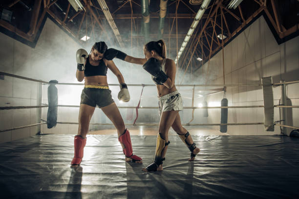 istock Female boxers fighting on a kick-boxing match in a ring. 927763668