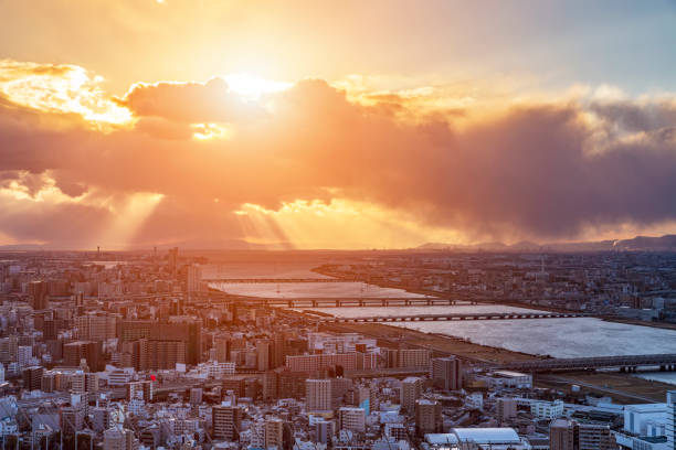 Aerial panorama over crowded highrise city beside river Osaka Japa