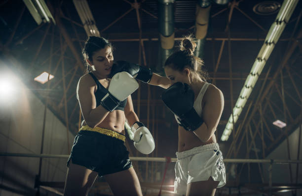 istock Female boxers having a fight during sports training in a ring. 927764430