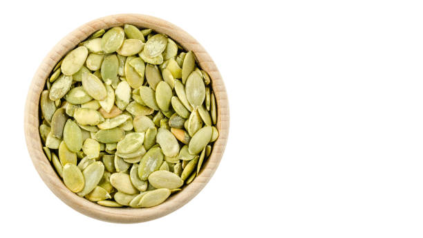 istock pumpkin seeds in bowl isolated, copy space, template 927767442