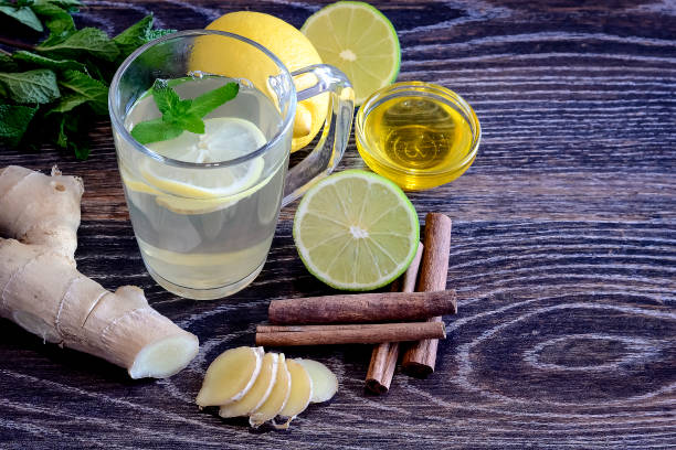 istock Drink from the lemon on the table. Lemon and ginger drink. The w 927770966