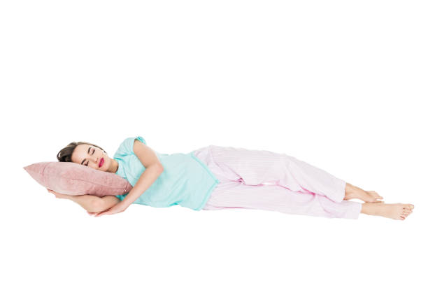 istock girl in pajamas sleeping on pillow isolated on white 927772160