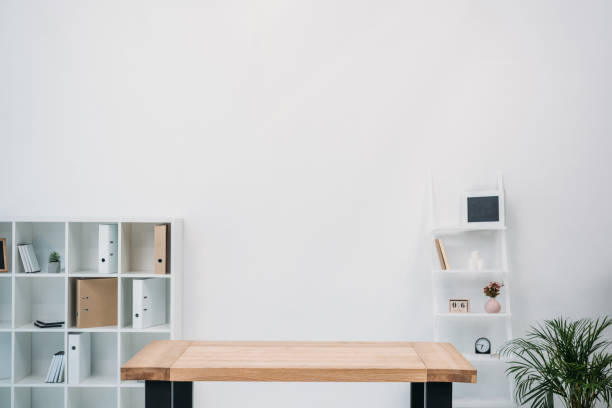 istock modern office interior with empty wooden table and folders on shelves 927772544