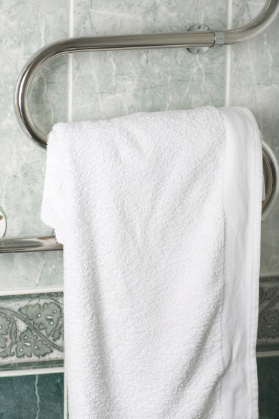istock Big towel is hanging on a bathroom heater. 927775424