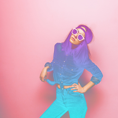 Woman in pink sunglasses, a blue shirt with polka dots and  jeans. Minimal trend. the double exposure effect with a gradient
