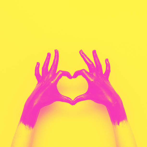 hands in black paint send heart hands in black paint send heart. love and minimal fashion concept. yellow and pink double color effect vaporwave photos stock pictures, royalty-free photos & images