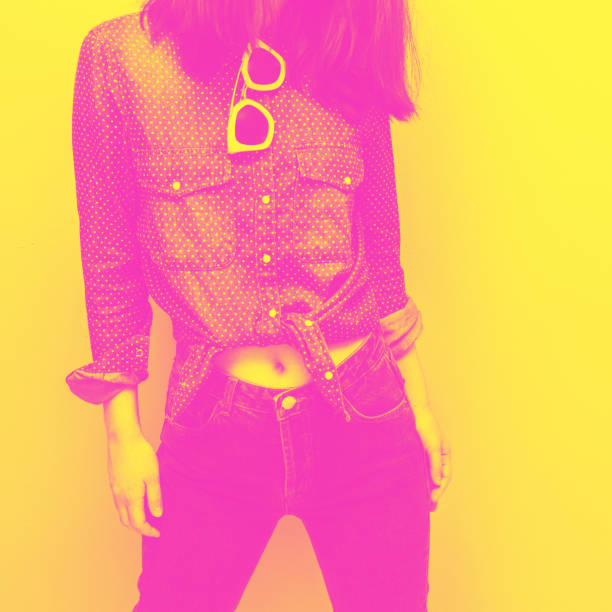 Blue shirt with white polka dots, dark jeans with a high waist and pink sunglasses. Summer and spring fashion. Minimal. yellow and pink double color effect