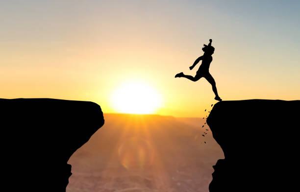 istock Woman landing after jumping over abyss. 927775740