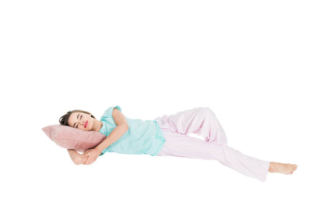 istock young woman in pajamas sleeping on pillow isolated on white 927776024