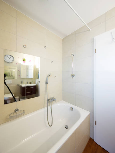istock Bathtub in bathroom with large tiles 927780378