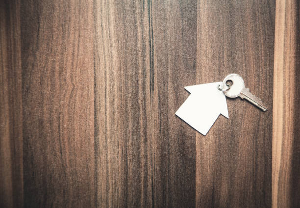 istock Key and house on the wood background. 927784772