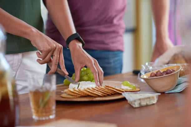 istock Anonymous woman's hands slicing cheese for appetisers 927785884