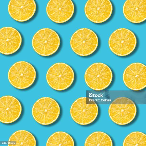 Lemon Slices Pattern On Vibrant Turquoise Color Background Stock Photo - Download Image Now