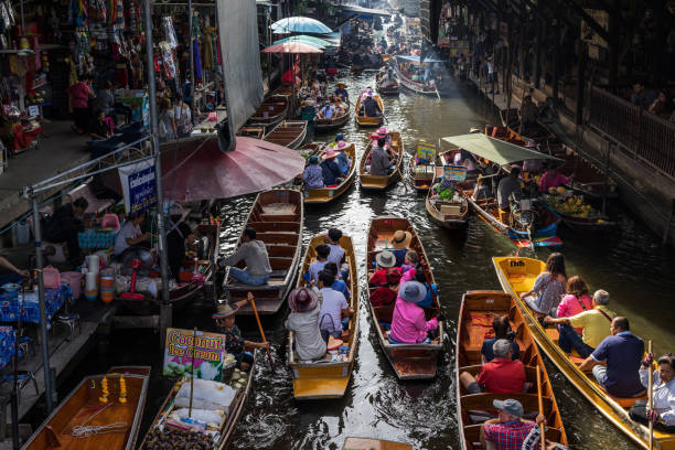 Traditional Thai floating market in Damnoen Saduak stock photo