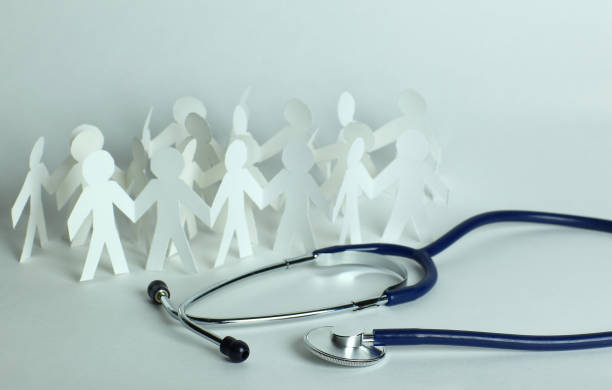 istock stethoscope and paper men on the table 927798764