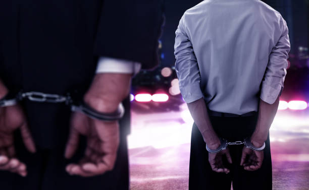 Two businessman in handcuffs stock photo