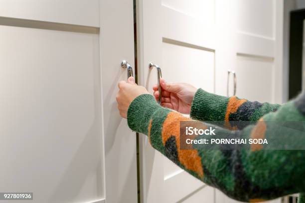 Women Hands Open The Cupboard Cabinet Door White Wooden Door Stock Photo - Download Image Now