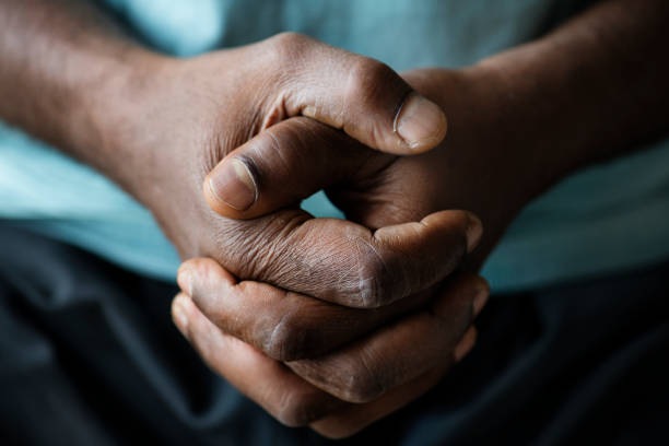 istock Closeup of black hands holding hand 927802606