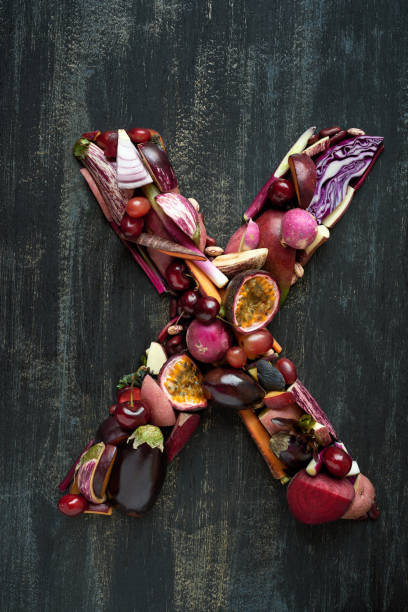istock Fruit and Veg alphabet letter arrangement on dark background 927806058