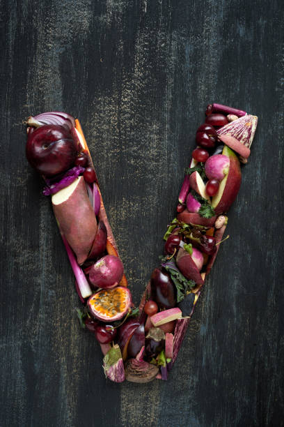 istock Fruit and Veg alphabet letter arrangement on dark background 927806064